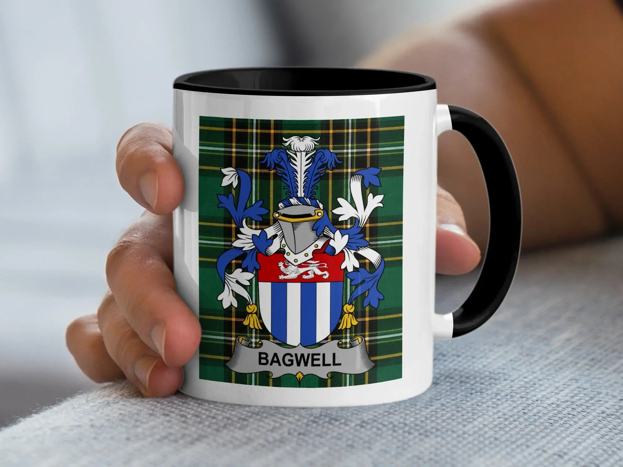 White mug with black rim featuring Bagwell family crest on plaid background.