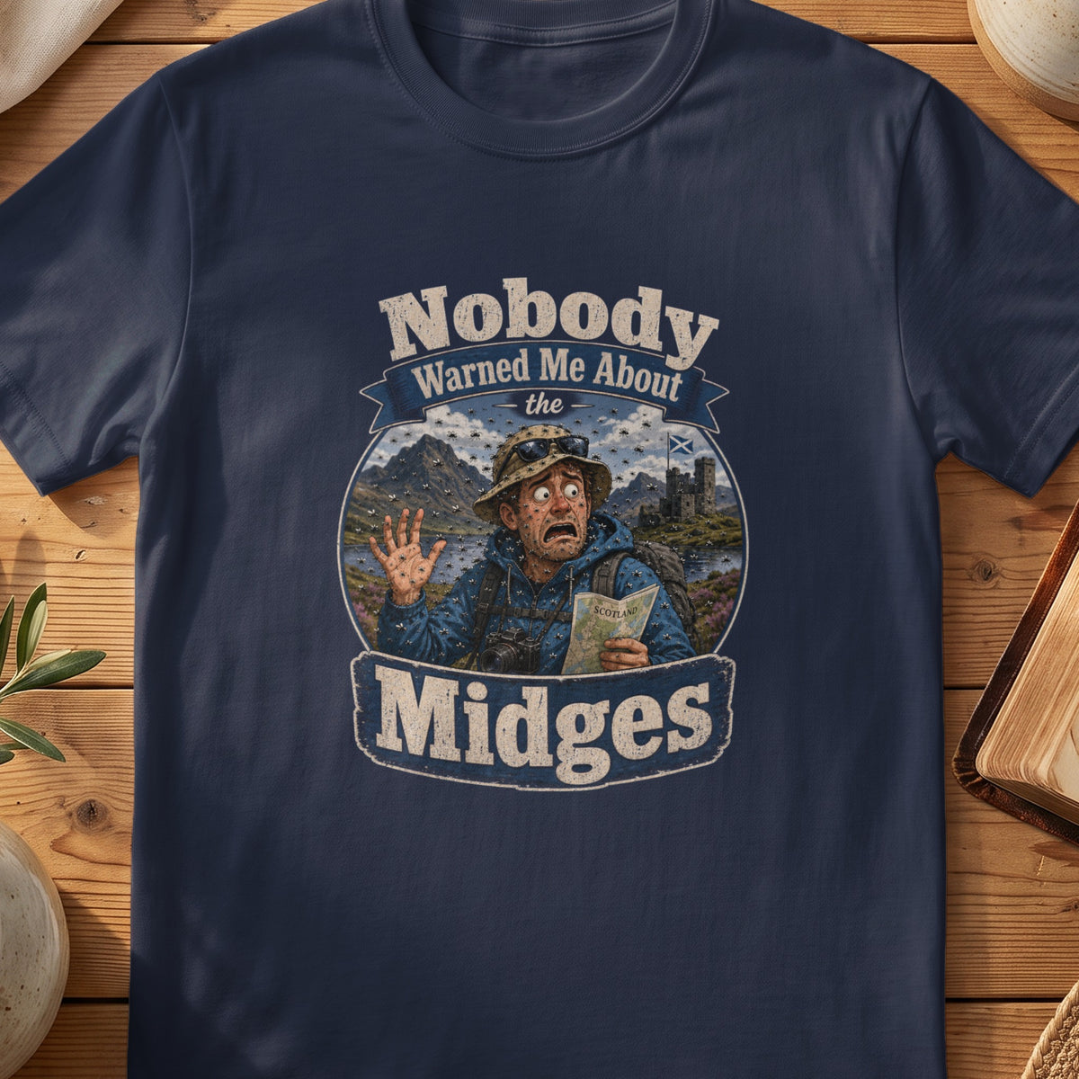 Navy Gildan 64000 unisex T-shirt flatlay with Nobody Warned Me About the Midges Scottish graphic design