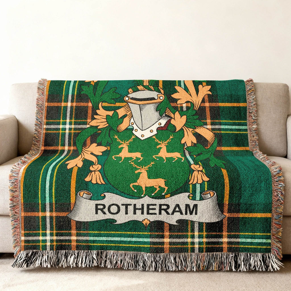 Woven throw blanket with Rotherham family crest on green plaid background.