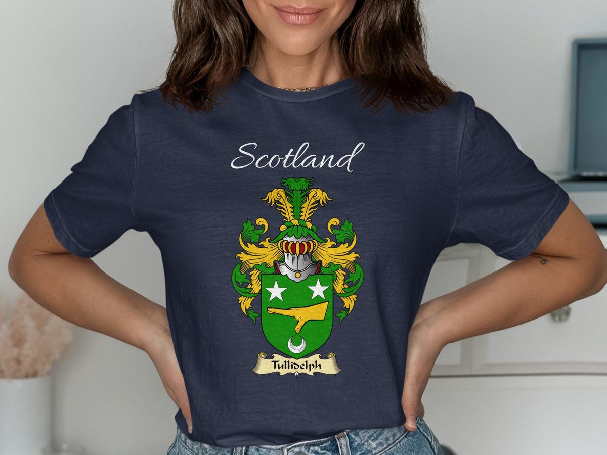 Model wearing the navy Tullidelph family crest T-shirt featuring “Scotland” and the surname banner.