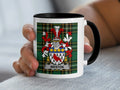 Mug with Weston family crest on plaid background.