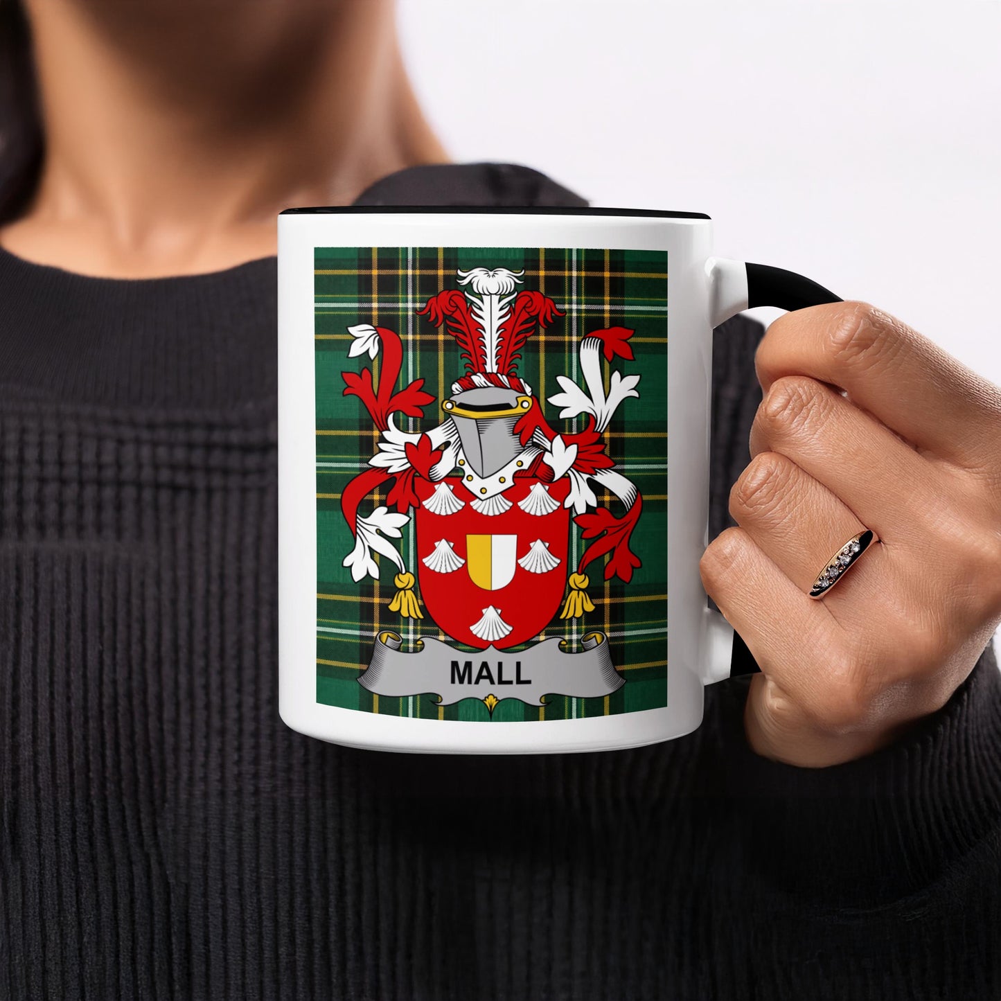 Mug with family crest on plaid background, text reads "MALL".