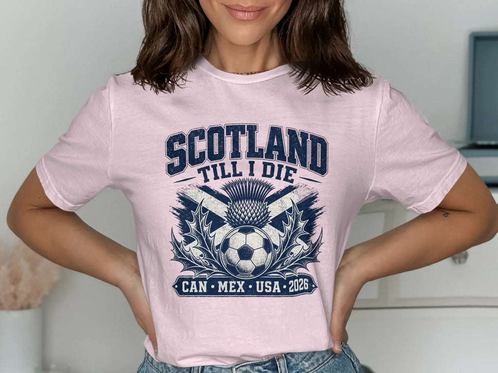 Pink t-shirt with "Scotland Till I Die" text, soccer ball, and thistle.