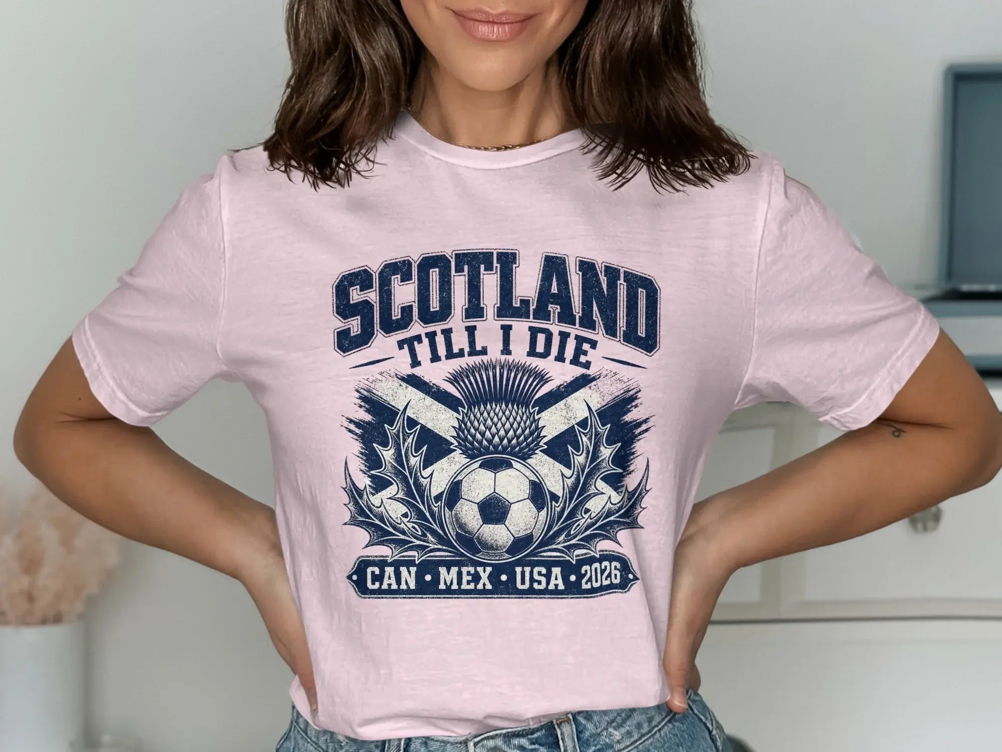 Pink t-shirt with "Scotland Till I Die" text, soccer ball, and thistle.