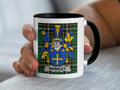 White mug with black handle featuring Brinkley family crest on plaid background.