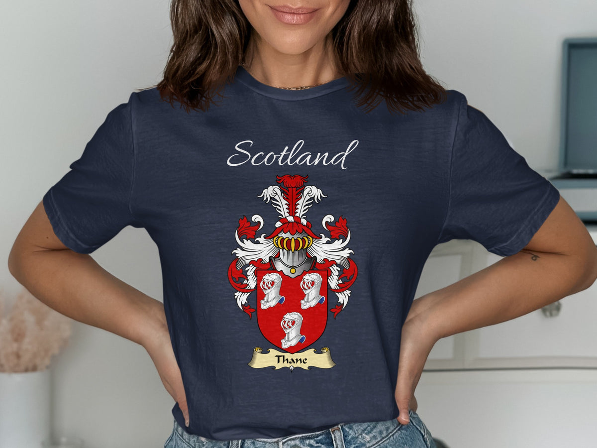 Model wearing the navy Thane family crest T-shirt featuring “Scotland” and the surname banner.