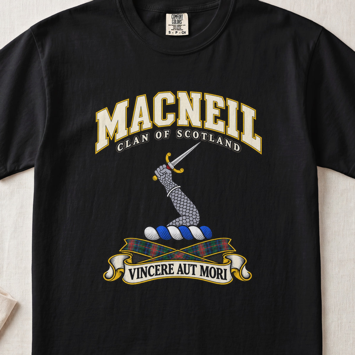 MacNeil Scottish clan T-shirt in Black, front view with an armoured arm holding a dagger and motto design.