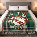 Tartan blanket with Gilmore family crest in center.