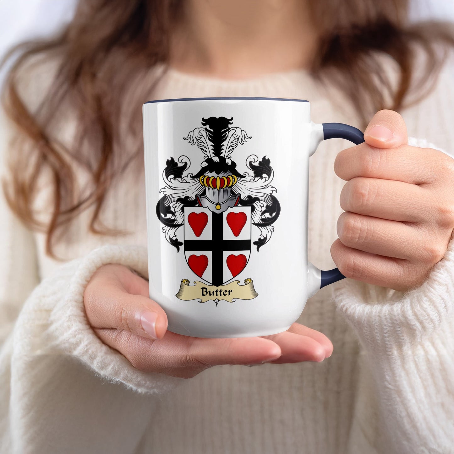 White mug with a black and red crest and "Butter" text.