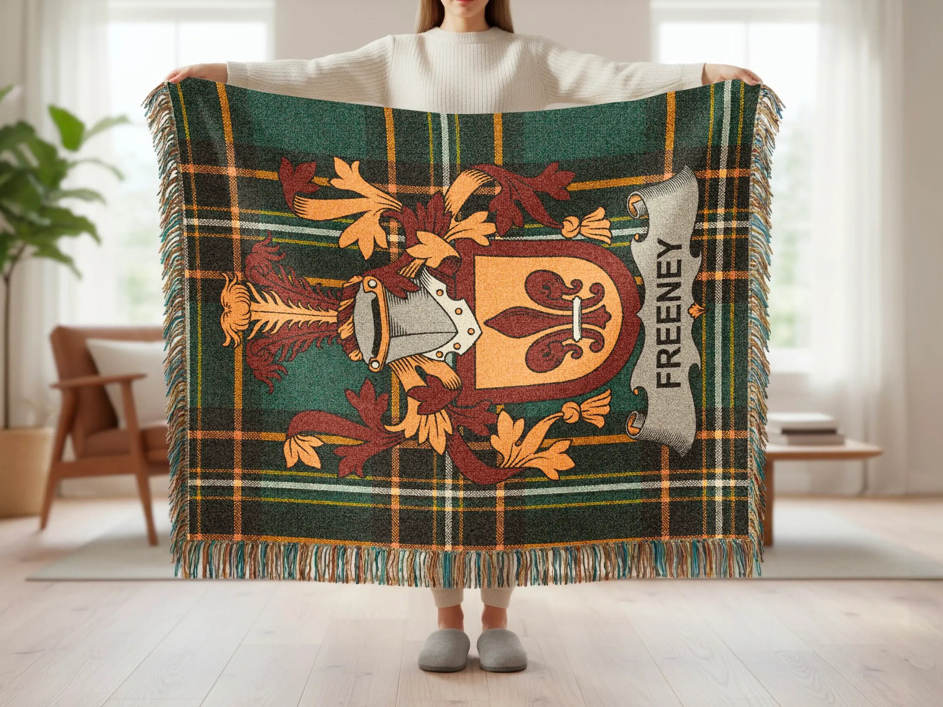 Freyney tartan blanket with a coat of arms and fringe.