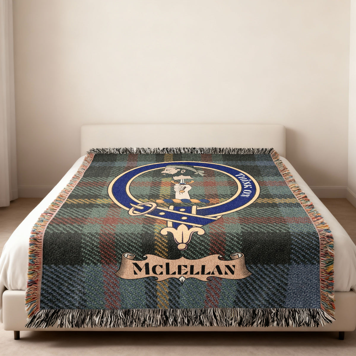 McLellan Scottish woven blanket spread across a bed, showing the full crest design and tartan background