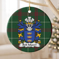 Beli Mawr ornament hanging from a pale wooden branch; three gold crowns on a blue shield on Welsh national tartan.