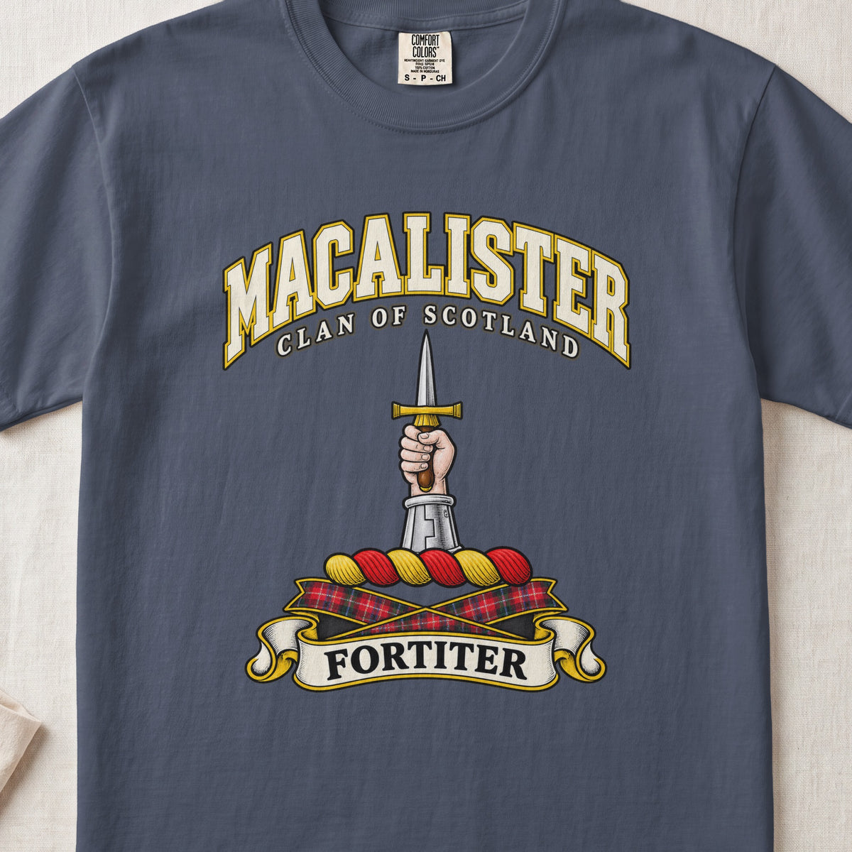 MacAlister Scottish clan T-shirt in Midnight, front view with an armored arm and hand holding an upright dagger and motto design.