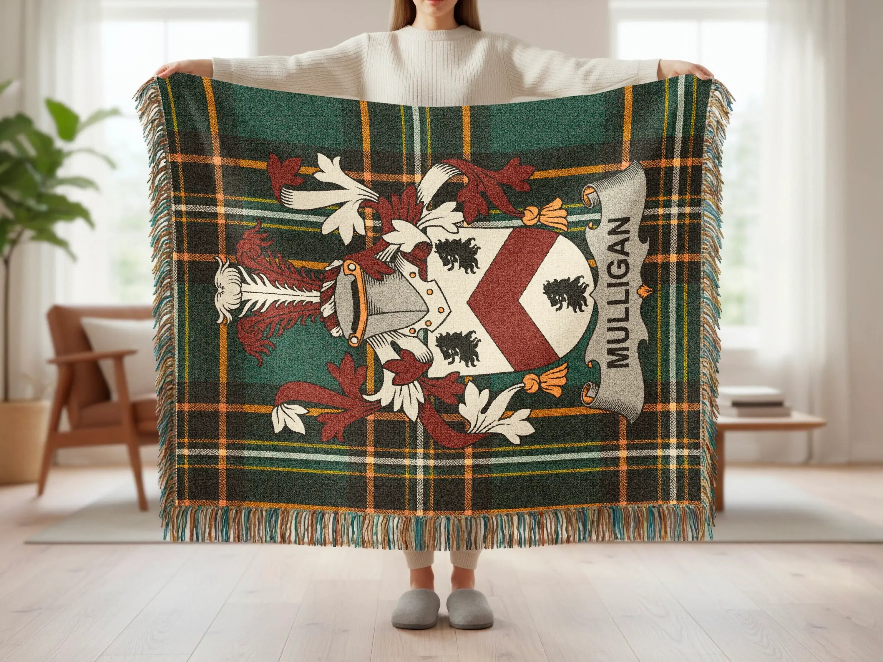 Mulligan tartan blanket with family crest displayed by a person.