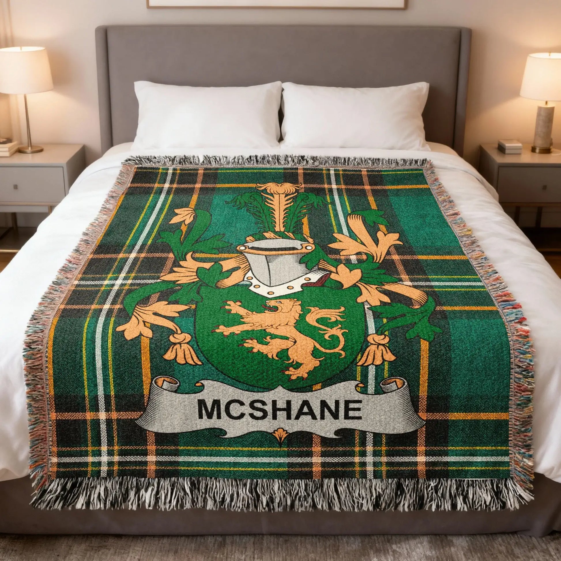 McShane tartan blanket with family crest on a bed.