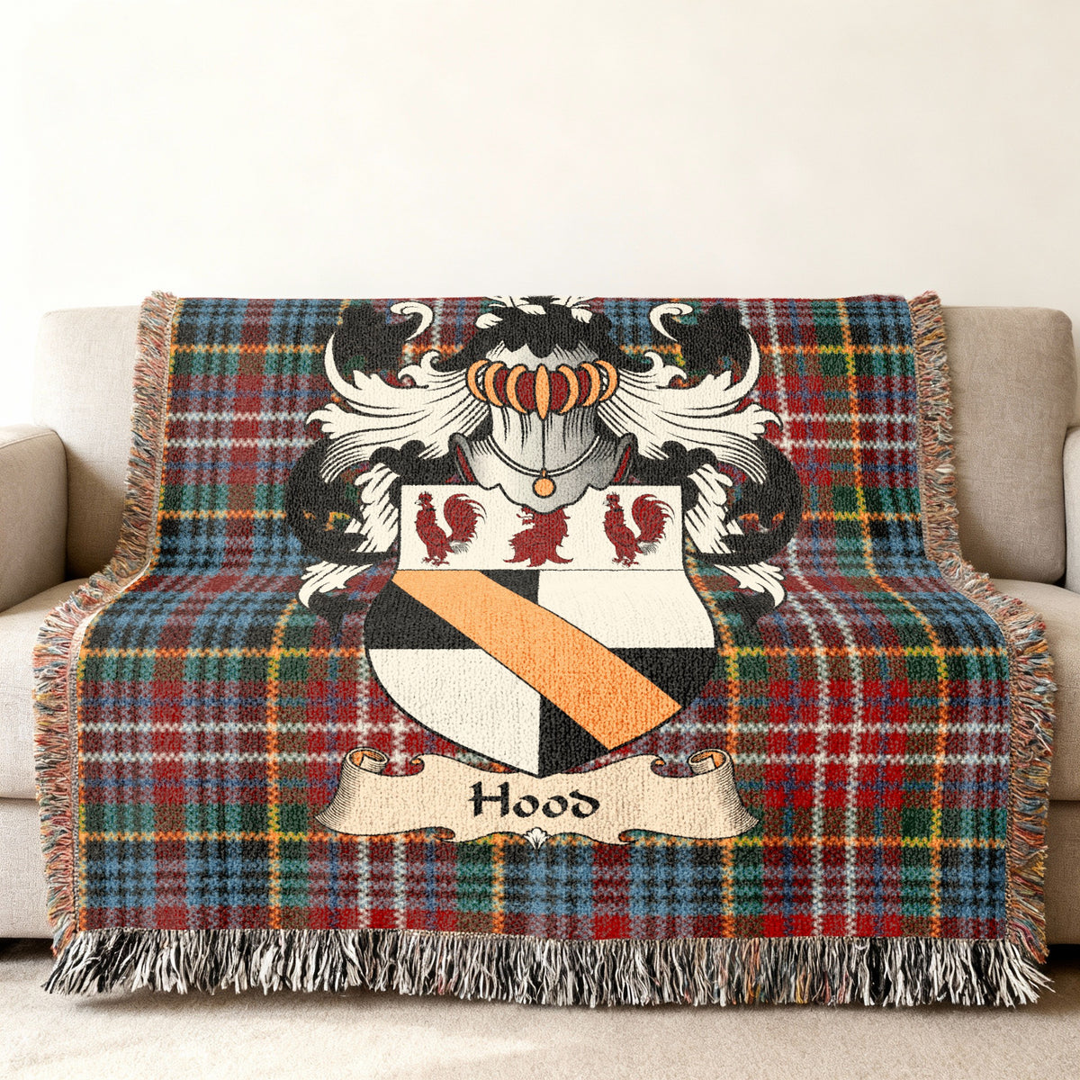 Hood family crest emblem on a Caledonia tartan woven blanket