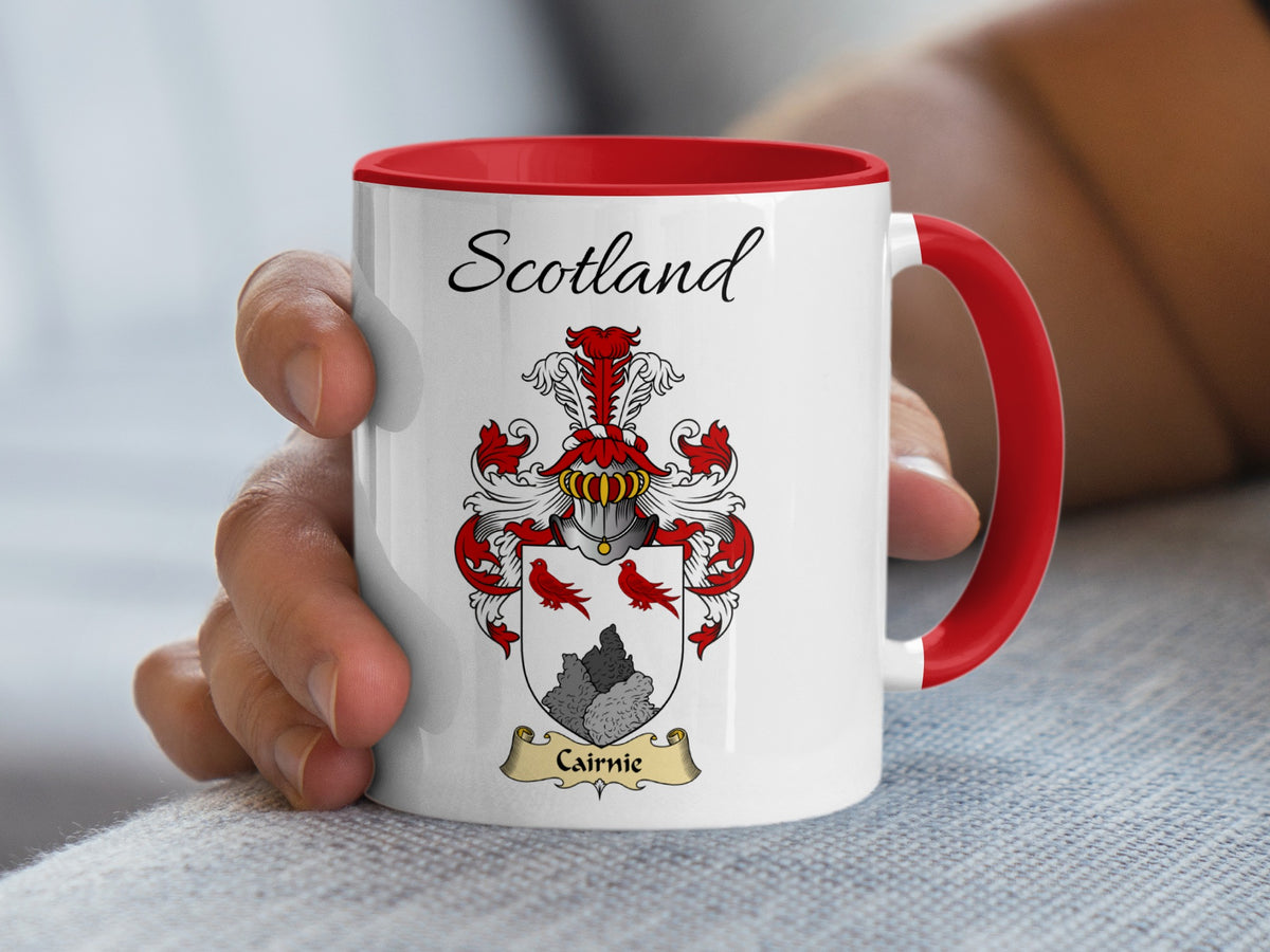 Red-accent Cairnie Scottish surname mug with matching handle and interior and coat of arms artwork beneath “Scotland”.