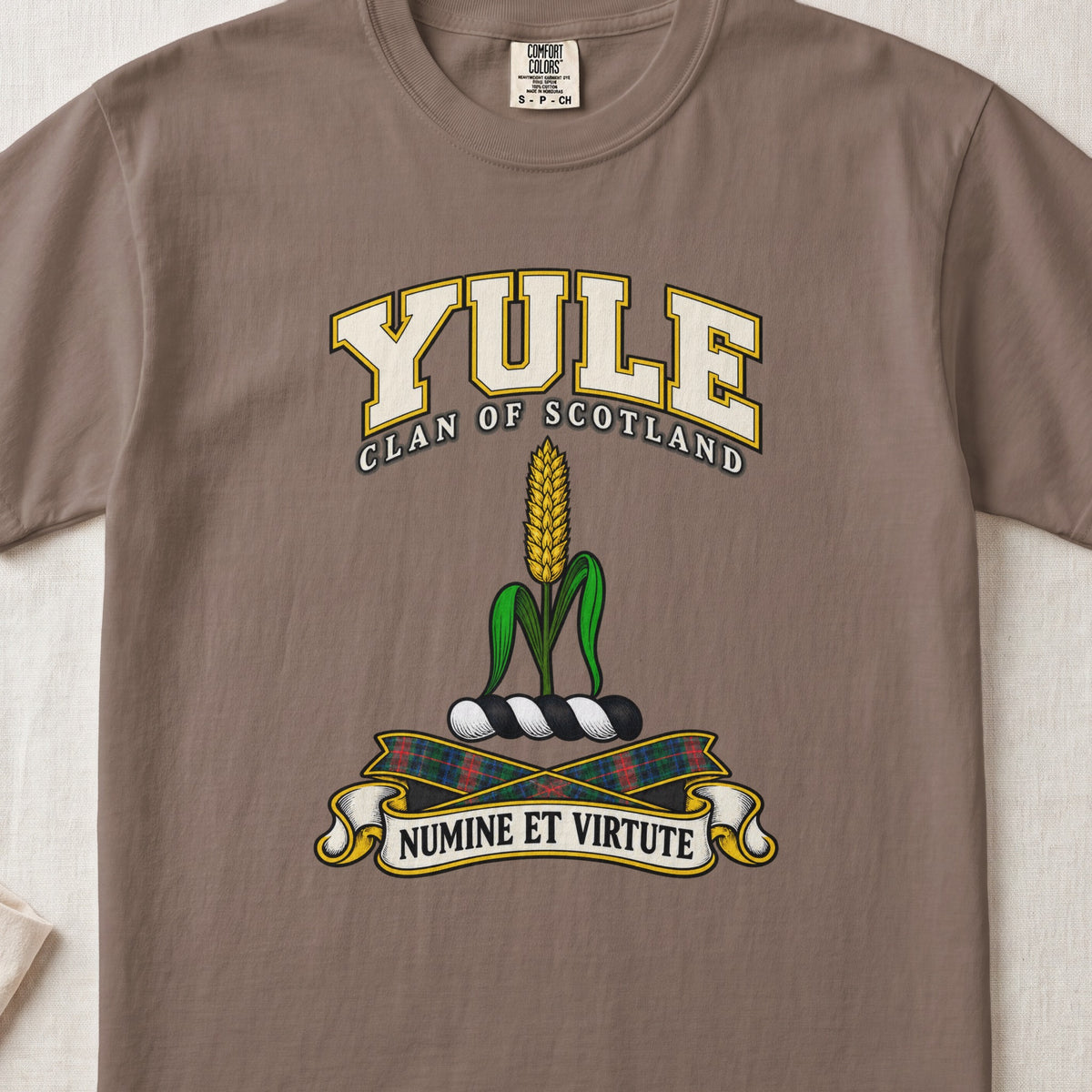 Yule Scottish clan T-shirt in Espresso, front view with a golden ear of grain with green leaves and motto design.