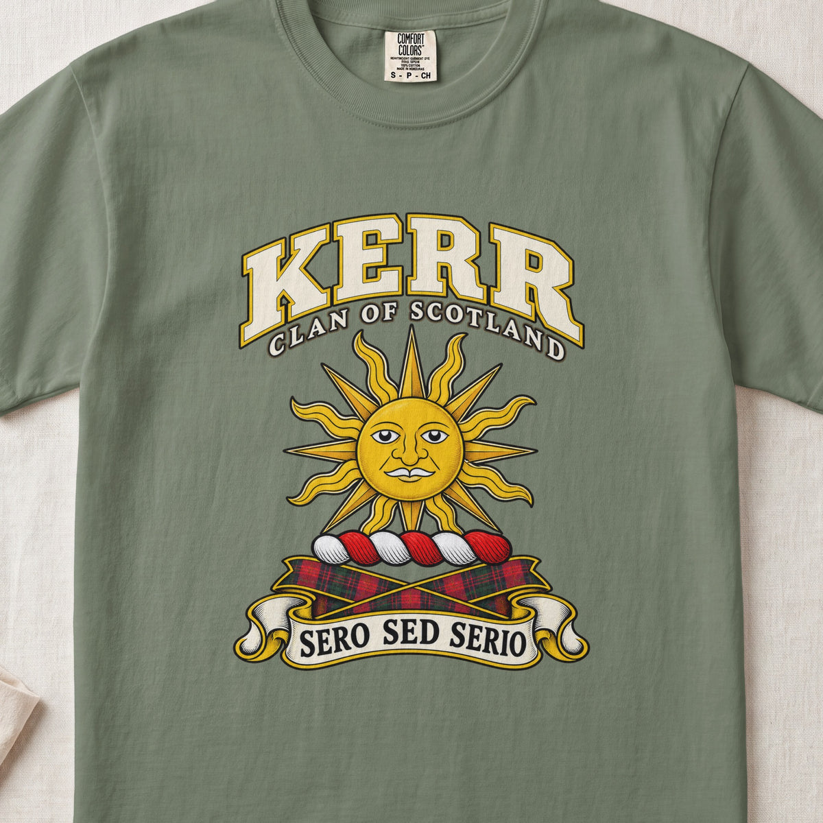 Kerr Scottish clan T-shirt in Moss, front view with a golden sun with a face and motto banner.