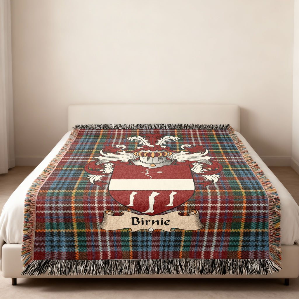 Birnie family crest emblem on a Caledonia tartan woven blanket