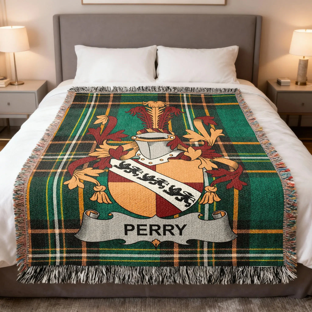 Plaid throw blanket with the Perry family crest centered on top.