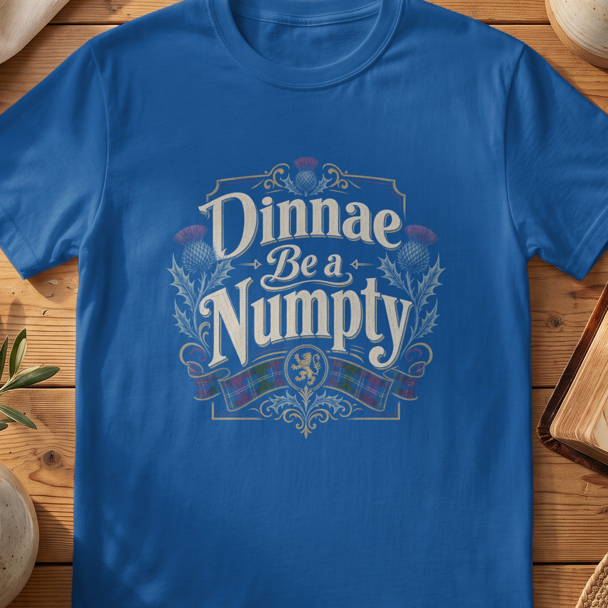 Blue t-shirt with "Dinnae Be a Numpty" text and Scottish thistle and lion emblems.
