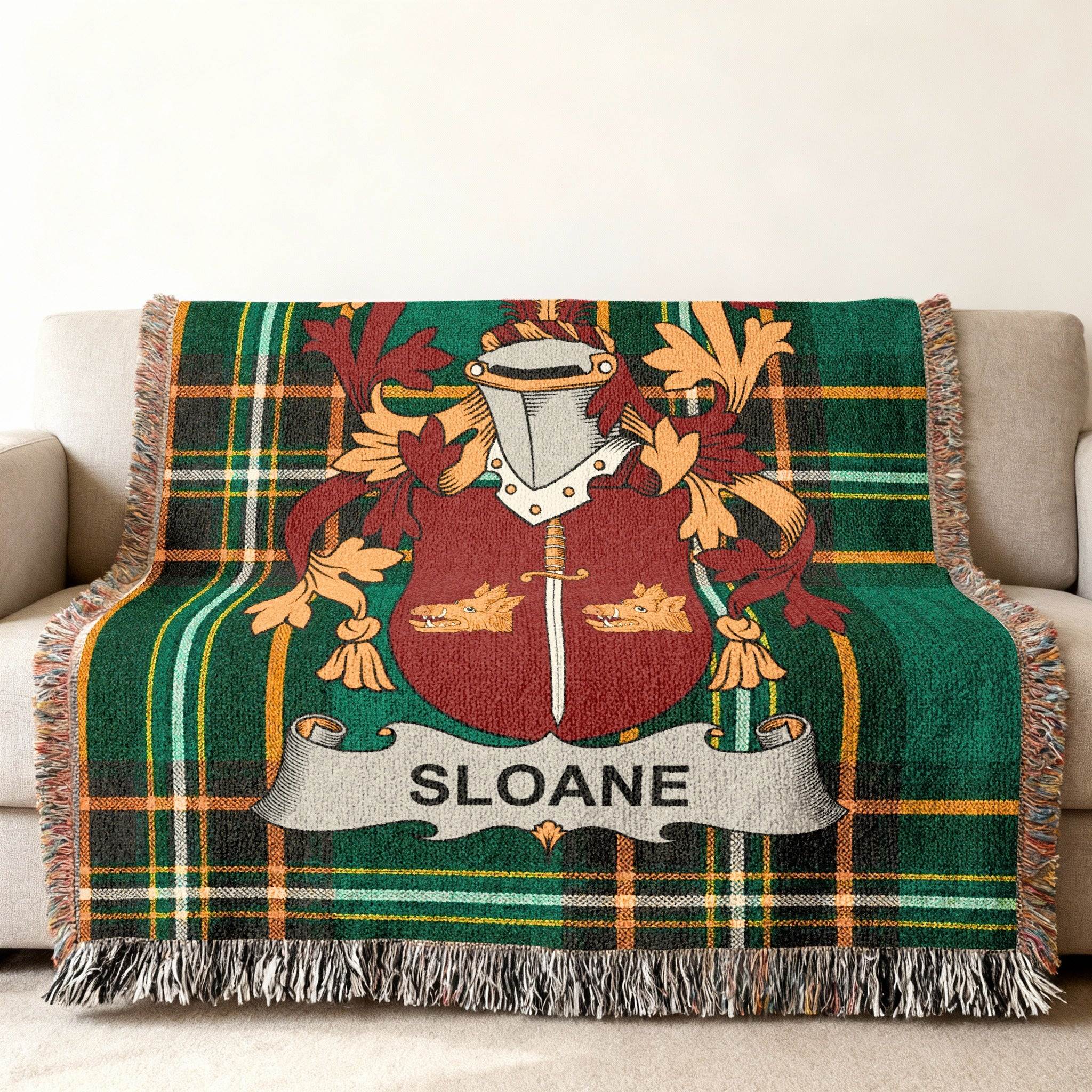Green plaid throw blanket with the SLOANE family crest.