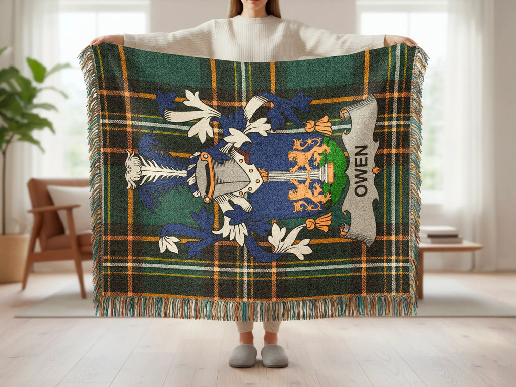 Plaid throw blanket featuring a blue and gold crest with "OWEN" text.