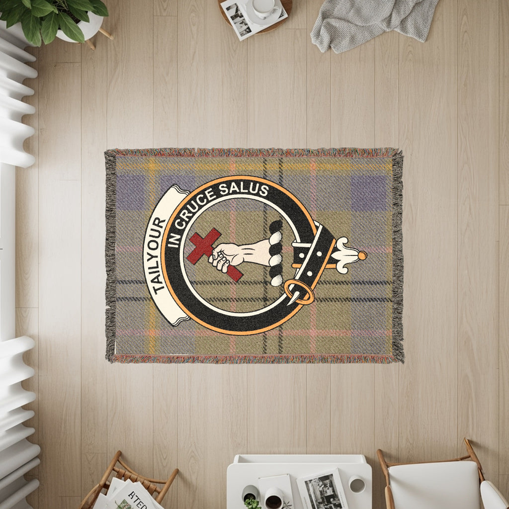Tailyour woven blanket displayed on a wall, featuring the crest badge and tartan background