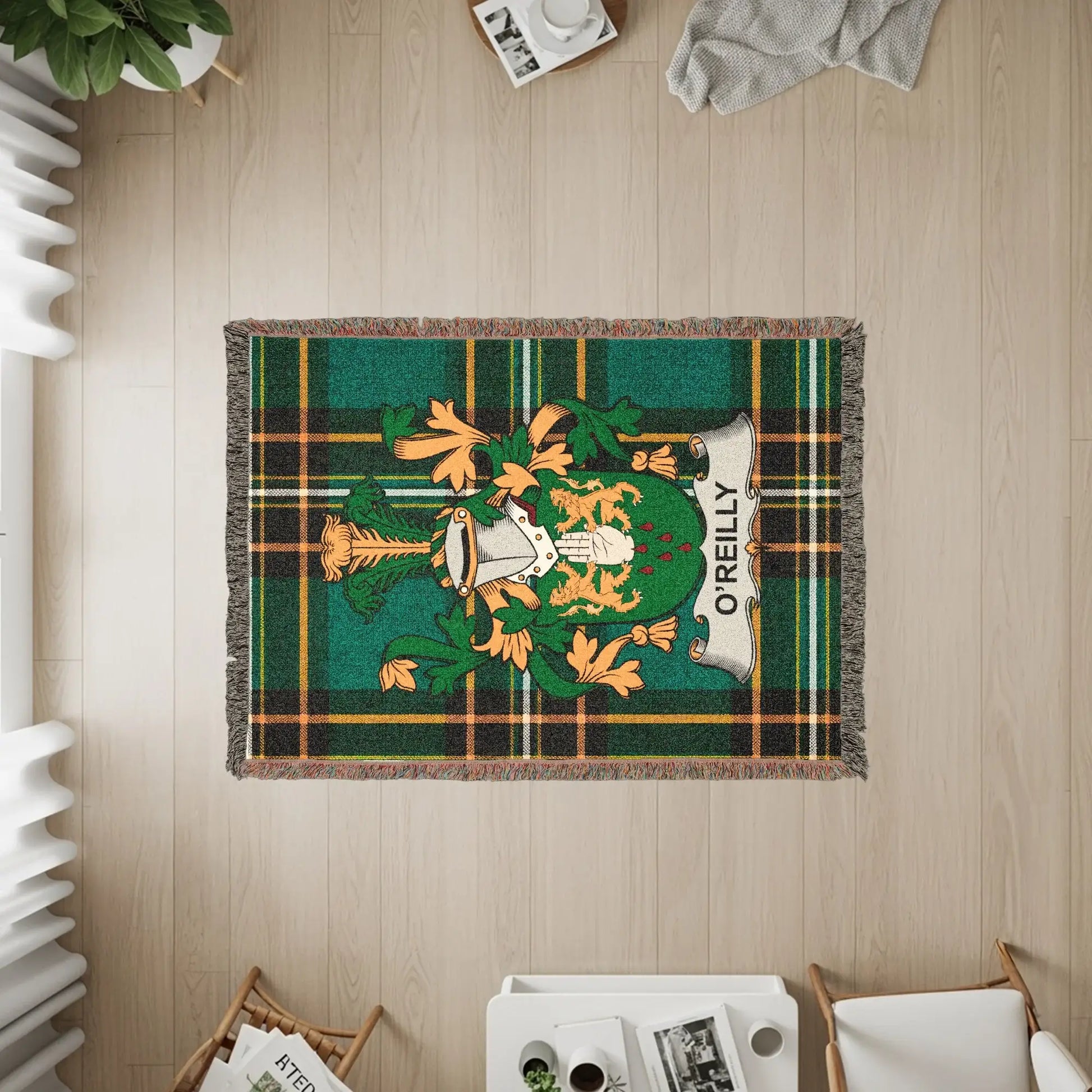 Green tartan throw blanket with O'Reilly family crest in the center.