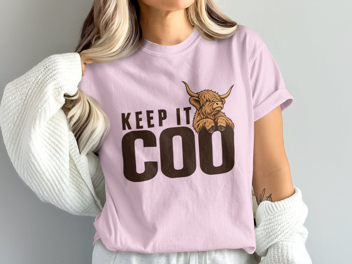 Model wearing the Keep It Coo Highland cow Comfort Colors T-shirt in Blossom