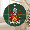 Eynon ornament hanging from a pale wooden branch; a gold chevron between three gold castles on a red shield on Welsh national tartan.