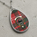 Oval pendant necklace featuring Nesbitt tartan and crest with text "I BYD IT".