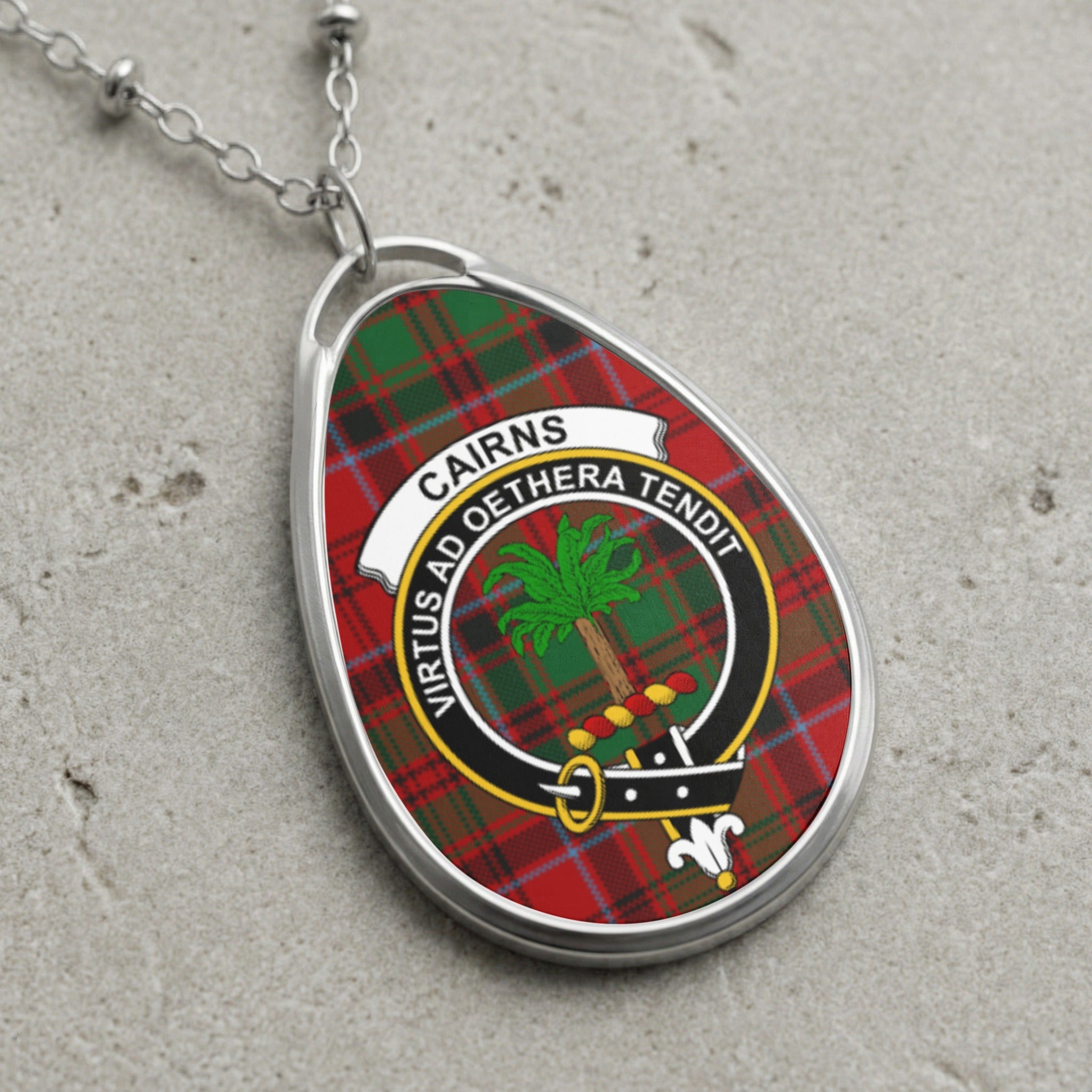 Cairns clan Scottish tartan necklace with clan crest on tartan background