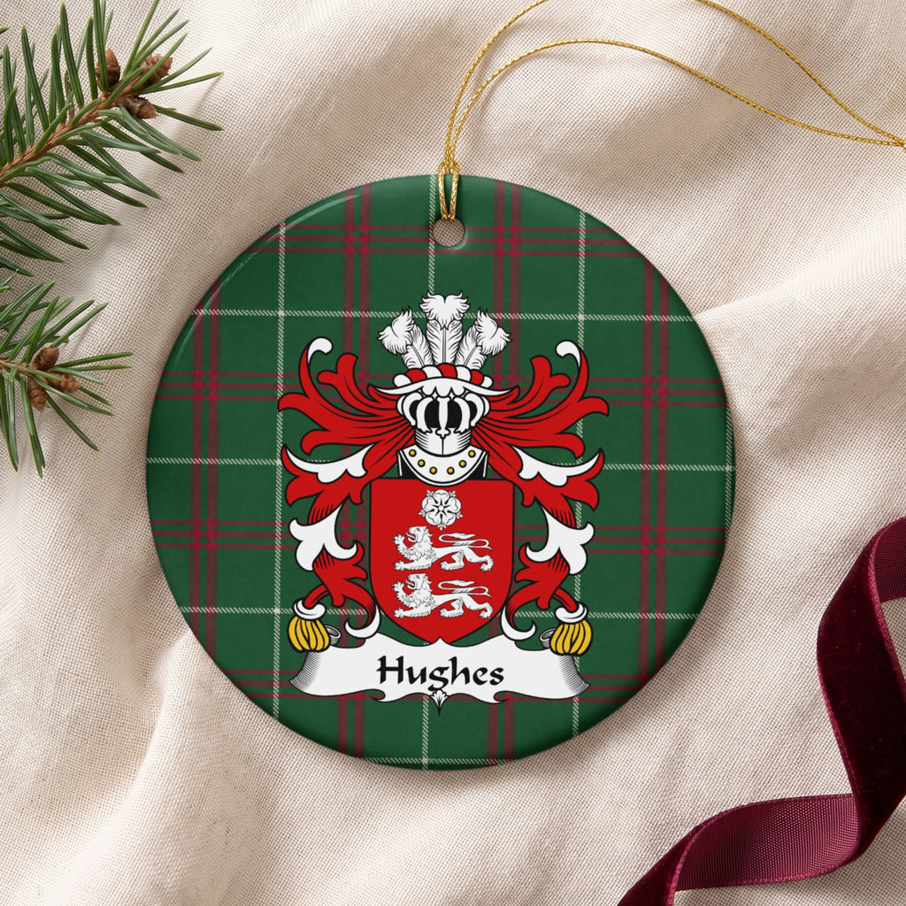 Hughes Style 3 ornament on cream fabric with gold string, evergreen and burgundy ribbon; two white lions beneath a white rose on a red shield on Welsh national tartan.