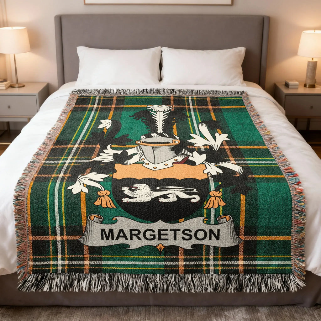 Tartan blanket with MARGETSON family crest on a bed.