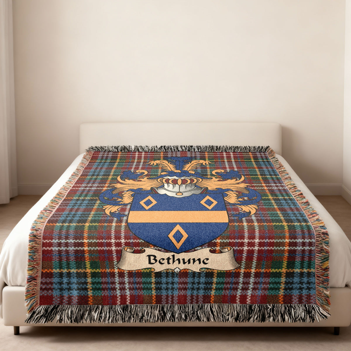 Bethune family crest emblem on a Caledonia tartan woven blanket