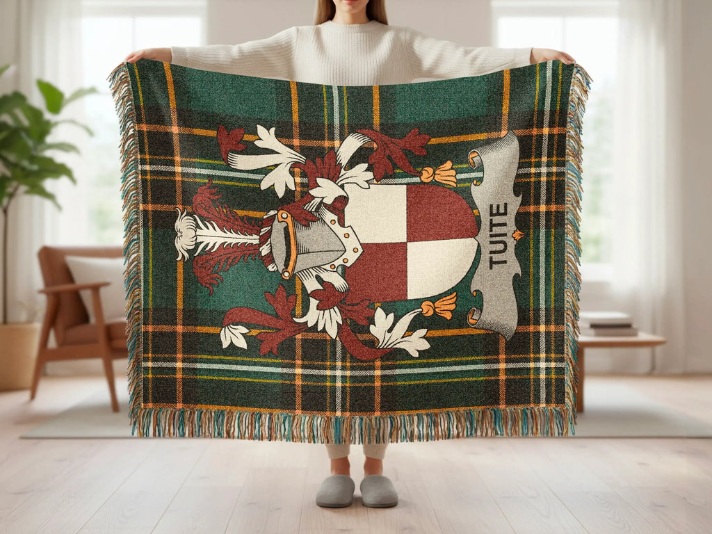 Tartan blanket with Tuite crest, held by a person.