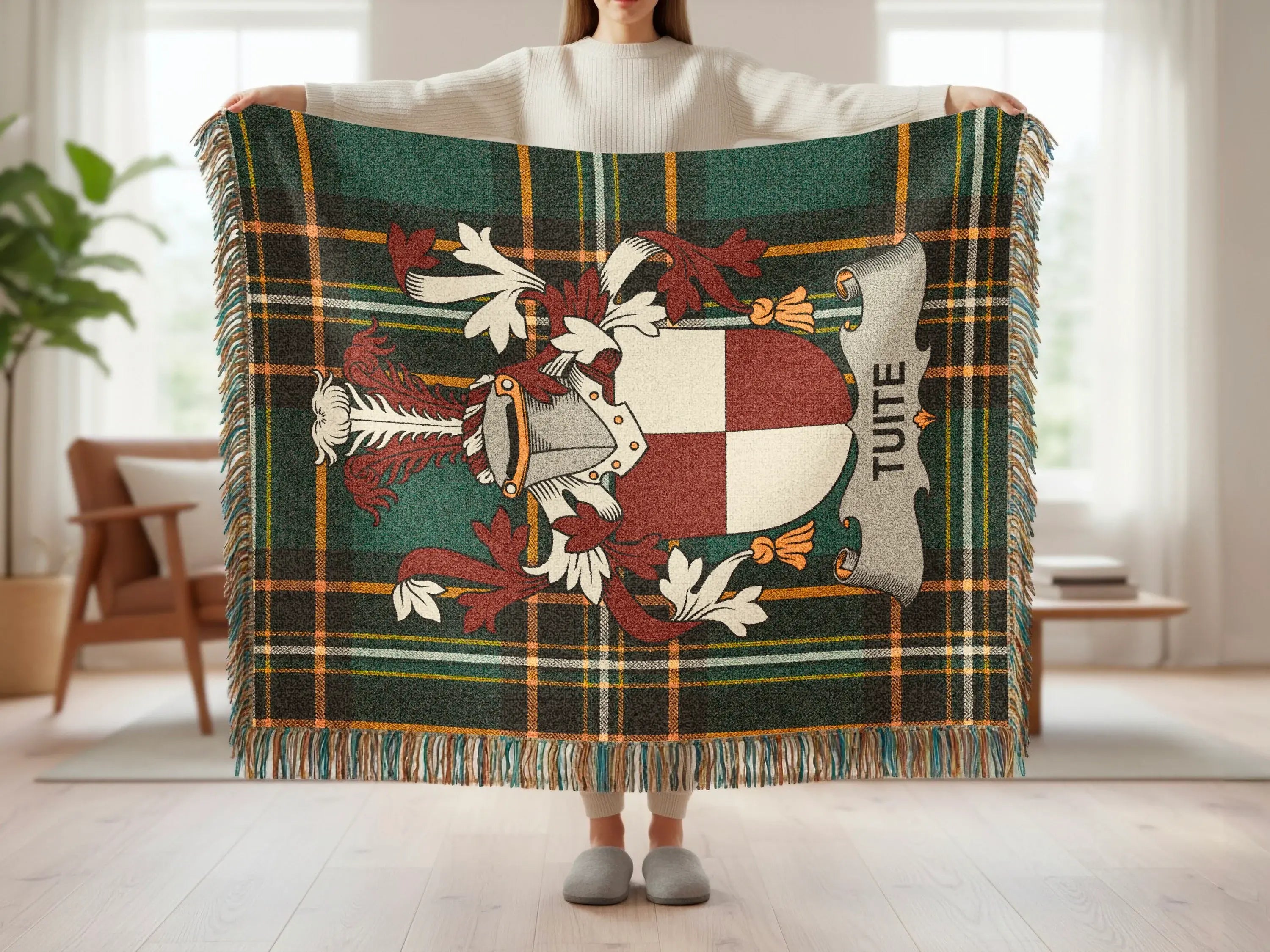 Tartan blanket with Tuite crest, held by a person.