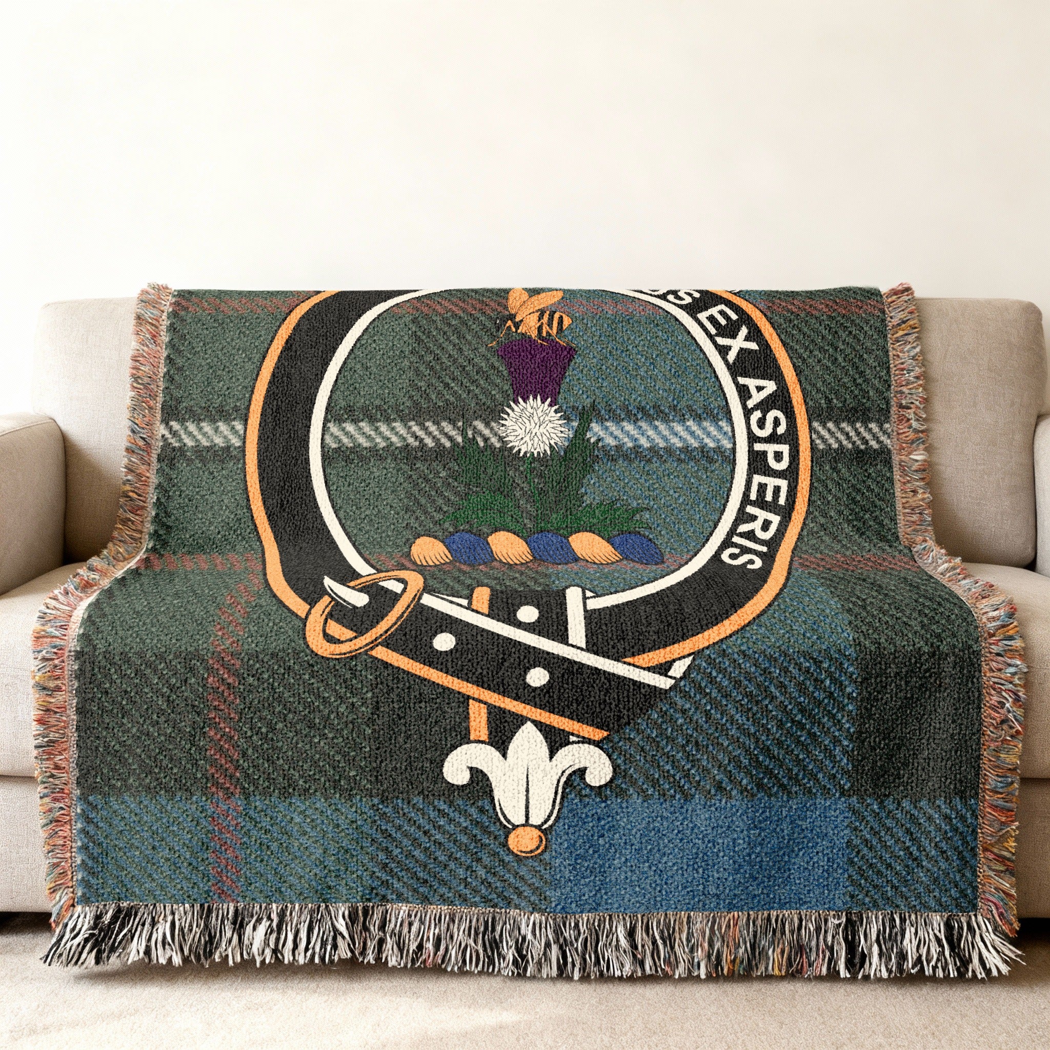 Ferguson clan crest with bee on thistle woven into tartan throw