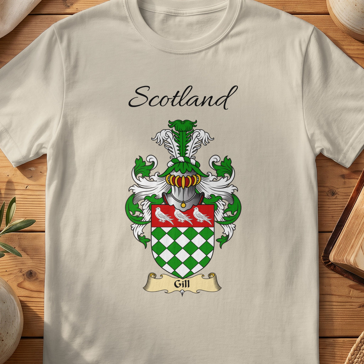 Sand Gill Scottish family shield T-shirt featuring green-and-white diamonds beneath white birds