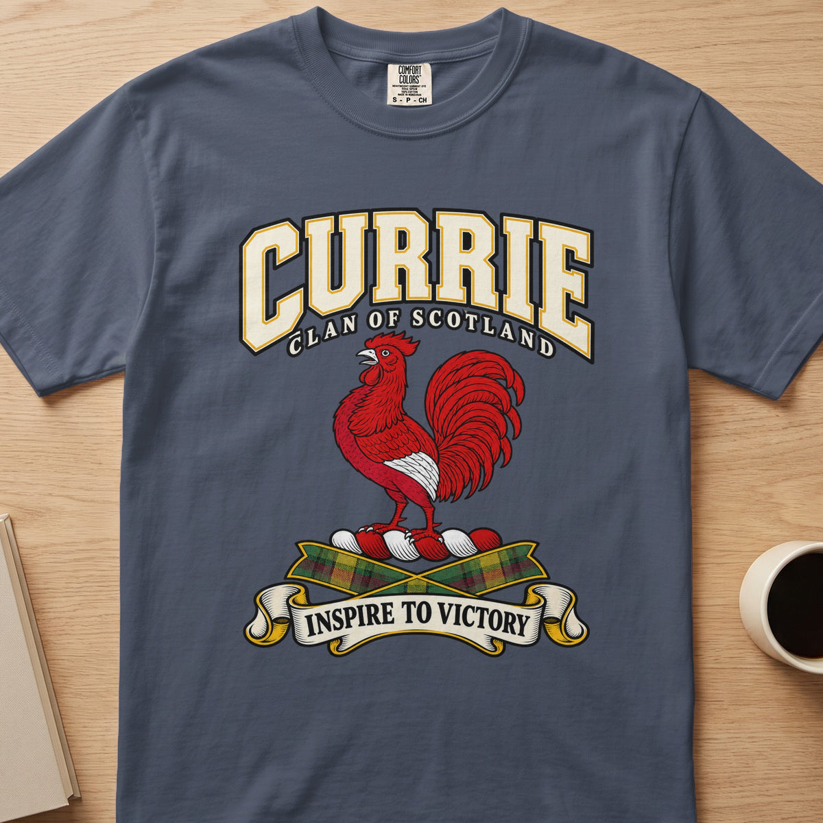 Currie clan crest with red rooster on a slate blue Comfort Colors T-shirt, front view