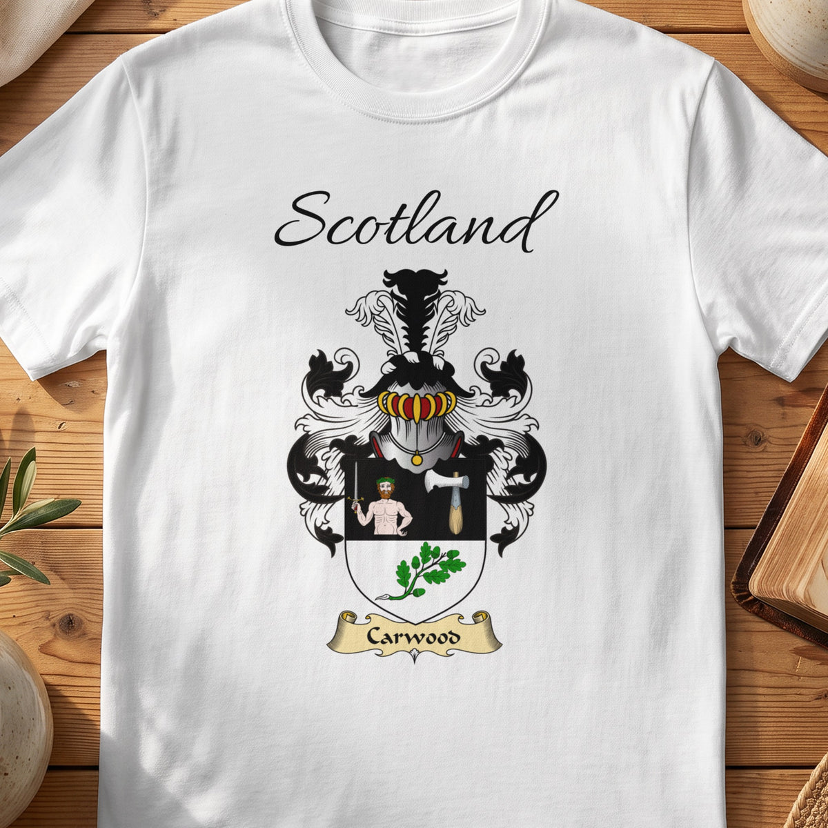 White Carwood Scottish family shield T-shirt featuring a human figure and axe above green leaves