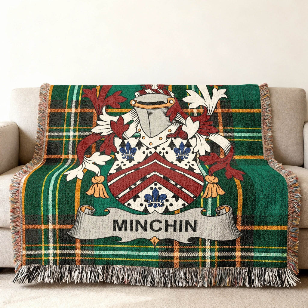 Woven plaid blanket with a family crest and the name MINCHIN.
