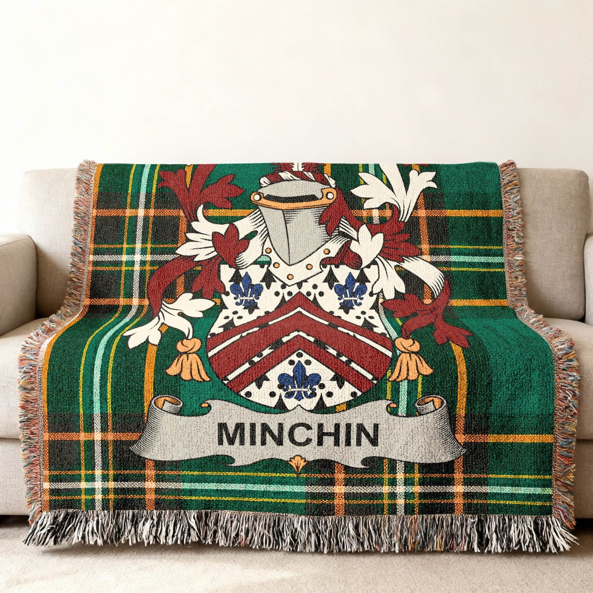 Woven plaid blanket with a family crest and the name MINCHIN.