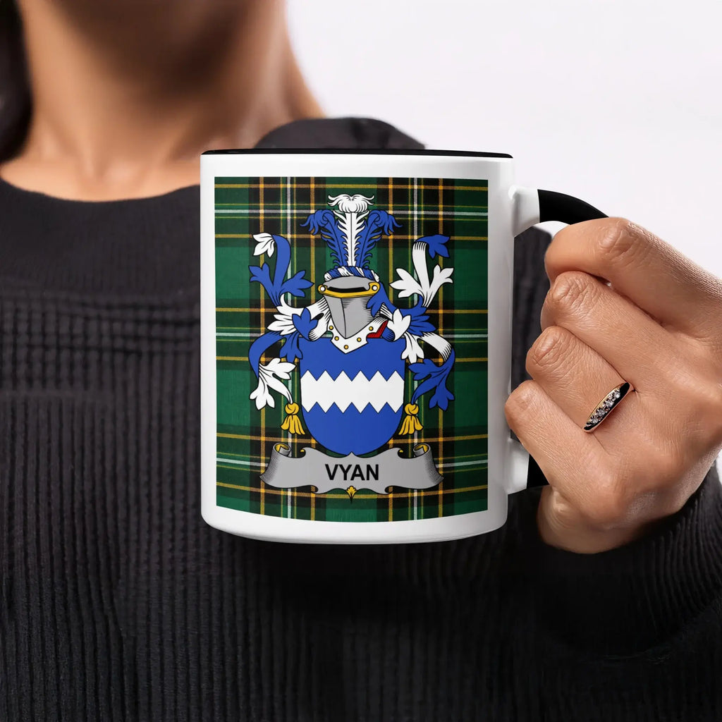 Vyan family crest on a mug with a plaid background.