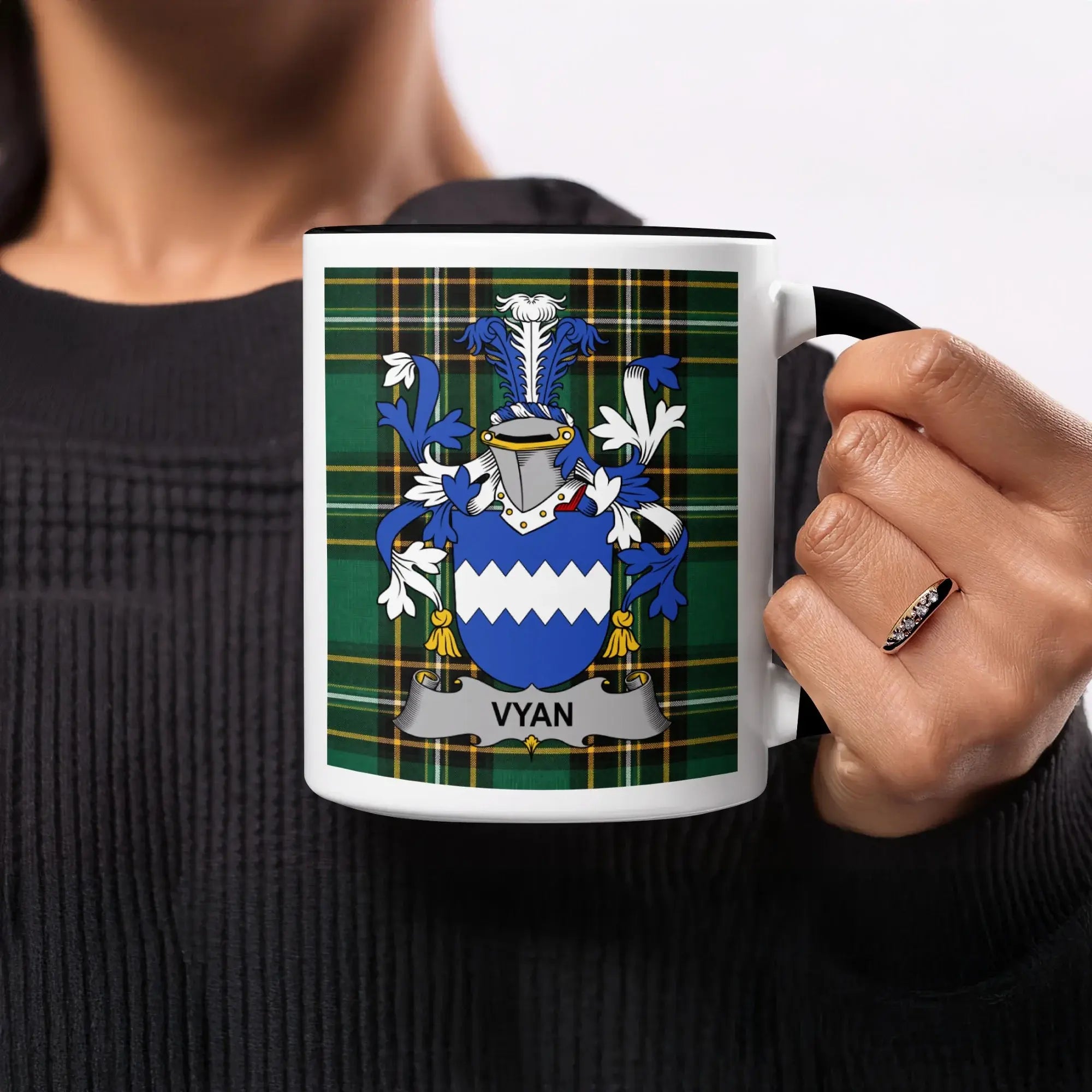 Vyan family crest on a mug with a plaid background.