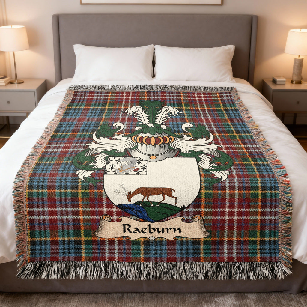 Raeburn family crest emblem on a Caledonia tartan woven blanket
