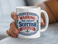 White mug with "Warning: May Contain Scottish Opinions" text and thistle graphic.