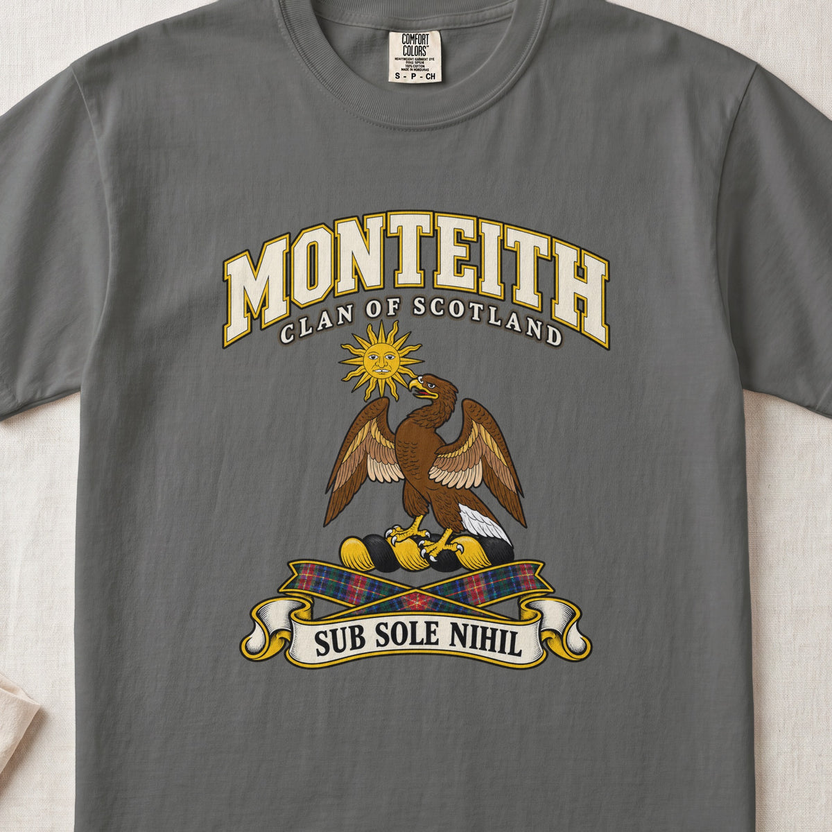 Monteith Scottish clan T-shirt in Pepper, front view with an eagle beneath a golden sun and motto design.